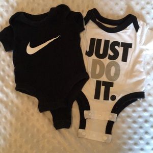 Two Nike onsies